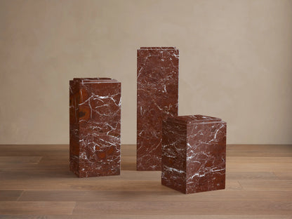 Front view of the red marble Marmont Pedestal with white veining and a stepped top. Matte lacquer finish.