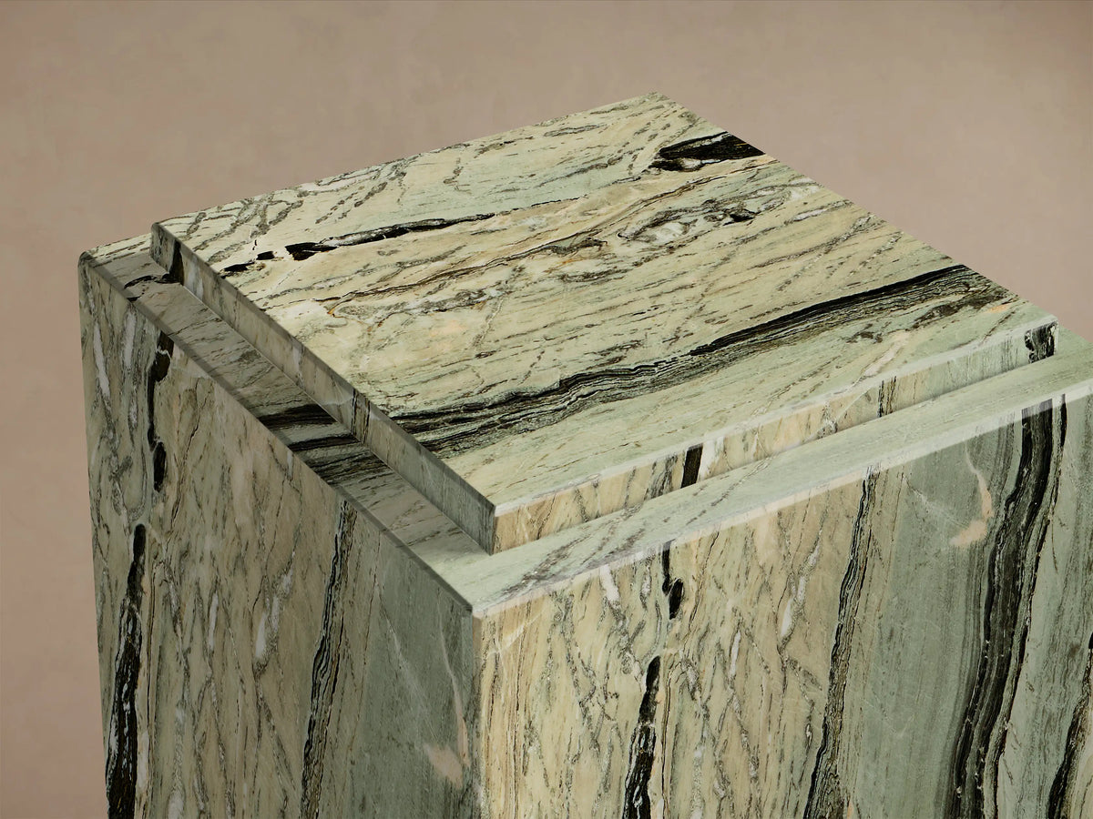 Front view of the green natural stone Marmont Pedestal, a rectangular pedestal with black and white veining and a matte finish.