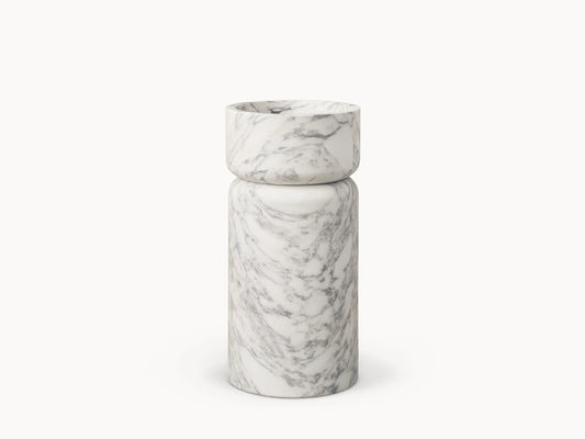 Front view of a white marble pedestal sink with prominent grey veining, featuring a rounded basin atop a cylindrical base.