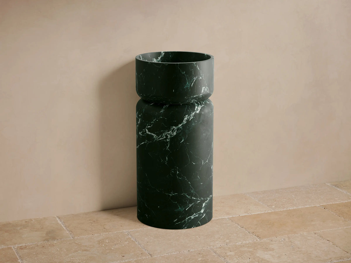 Front view of the dark green marble Vaso Pedestal Sink with white veining, featuring a cylindrical base and bowl.