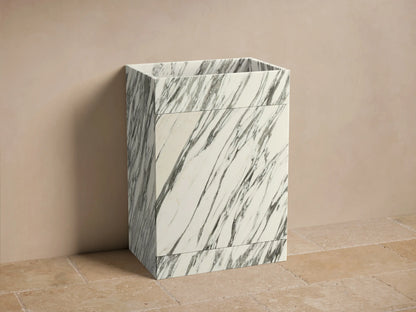Front view of the Vertiz Pedestal Sink with Storage. White marble with prominent dark gray veining, featuring a sleek rectangular design.