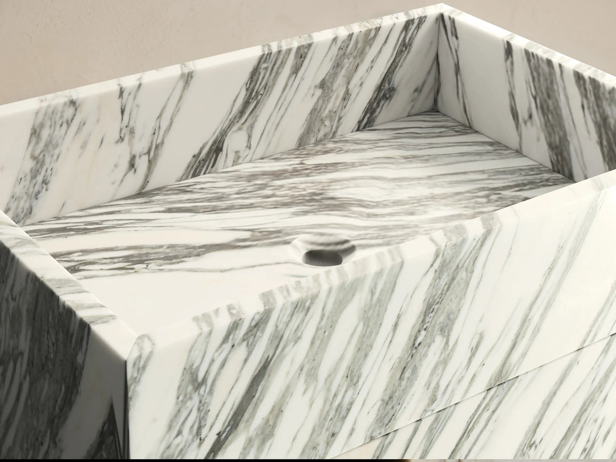 Front view of the white and dark gray marbled natural stone Vertiz Pedestal Sink with Storage.