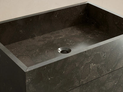 Front view of the dark mottled honed stone Vertiz Pedestal Sink with Storage, showcasing natural variations.