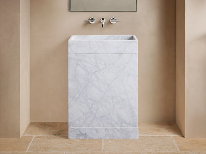 Close-up of a white marble sink with grey veining, featuring a rectangular basin and a central circular drain.