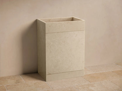 Front view of a beige honed stone Vertiz Pedestal Sink with Storage, featuring a rectangular basin and subtle natural patterns.