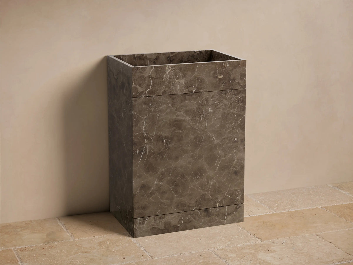 Front view of the dark brown marbled Vertiz Pedestal Sink with Storage, showcasing natural stone veining and a square basin.