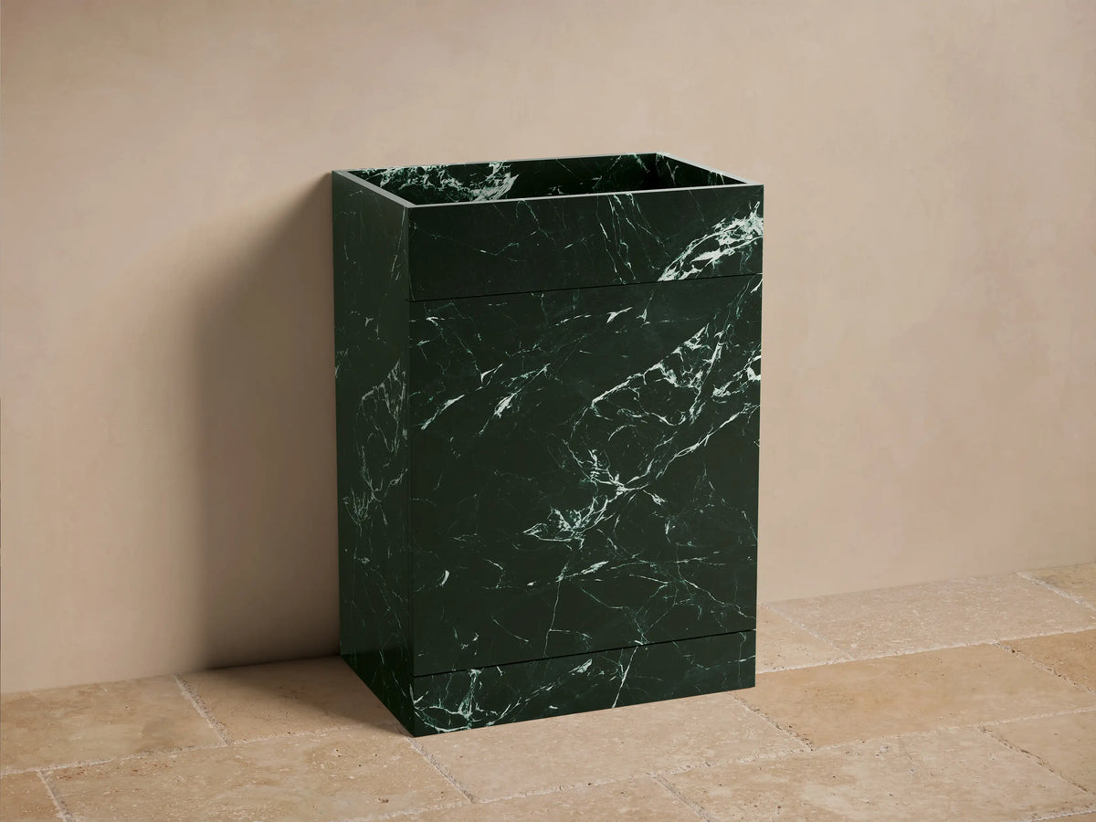 Front view of the dark green marble Vertiz Pedestal Sink with Storage, displaying intricate white veining.