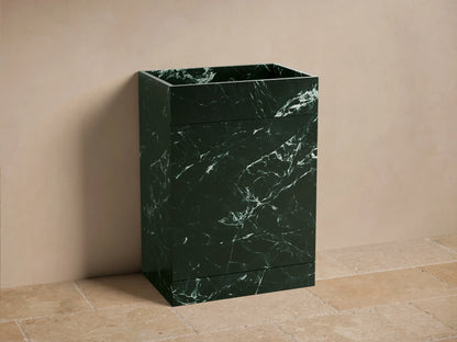 Front view of the dark green marble Vertiz Pedestal Sink with Storage, displaying intricate white veining.