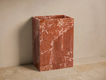 Front view of the Vertiz Pedestal Sink with Storage, made from red marble with white veining, featuring a rectangular basin.