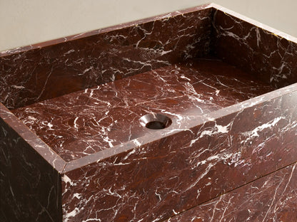 Front view of a brown marble Vertiz Pedestal Sink with Storage, featuring prominent white veining and a rectangular basin.