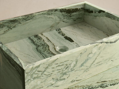 Front view of the light green natural stone Vertiz Pedestal Sink with Storage, featuring dark green and black veining.
