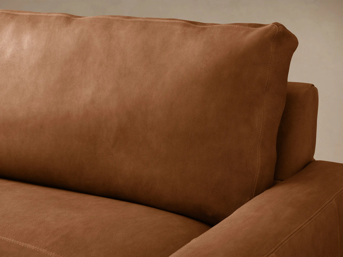 Remington Two-Piece Chaise Sectional in rich, cognac leather. Left-facing chaise, three-cushion sofa on wood floor.