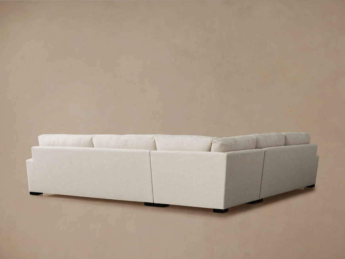 Light oatmeal-colored Remington Three-Piece Corner Sectional showing a plush back cushion, wide armrest, and textured seat.