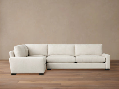 Remington Two-Piece Sectional, L-shaped, upholstered in light beige fabric, with plush cushions on a wood floor.