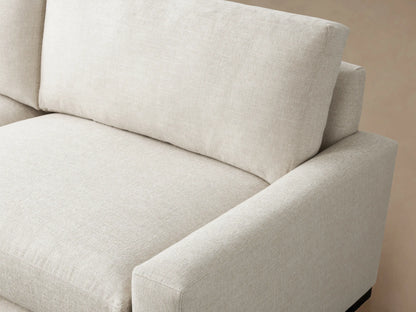 Remington Two-Piece Sectional, L-shaped, in a light natural fabric, with clean lines, on a wood floor against a neutral wall.