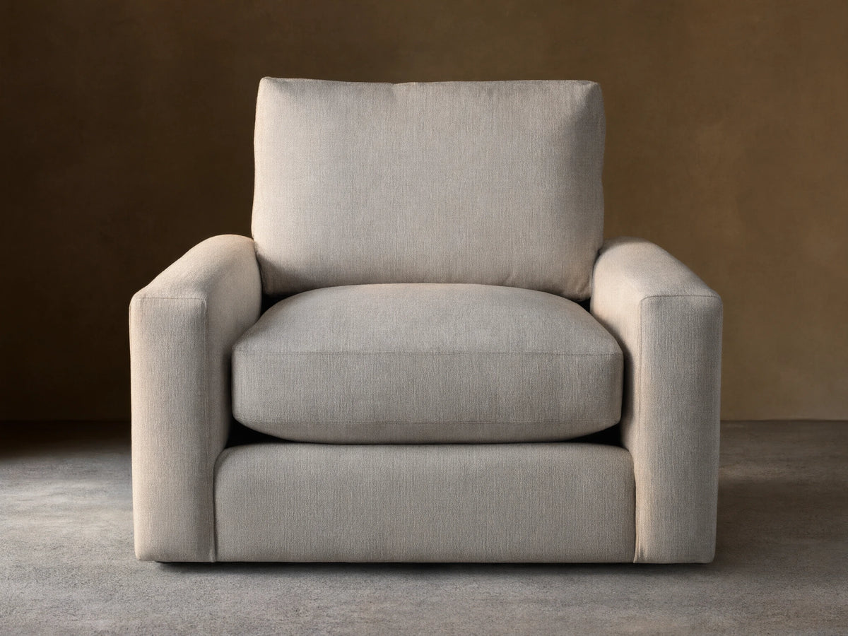 Front view of an oatmeal-colored Remington Swivel Chair, featuring a boxy design with thick cushions and wide arms.