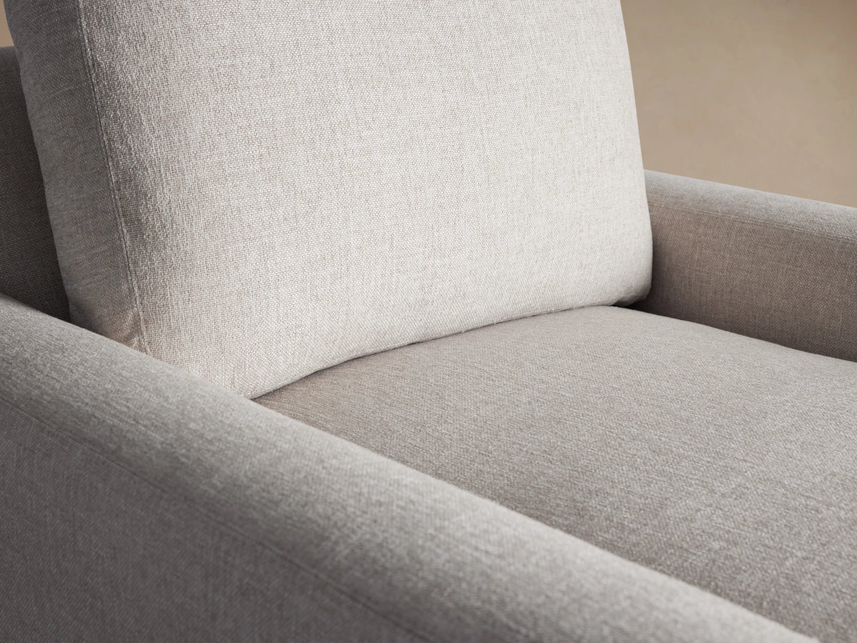 Front view of an oatmeal-colored Remington Swivel Chair, featuring a boxy design with thick cushions and wide arms.