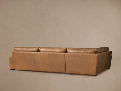 Close-up of Remington Leather Two-Piece Sectional, showing warm brown Saratoga Chocolate leather, soft cushions, and visible stitching.