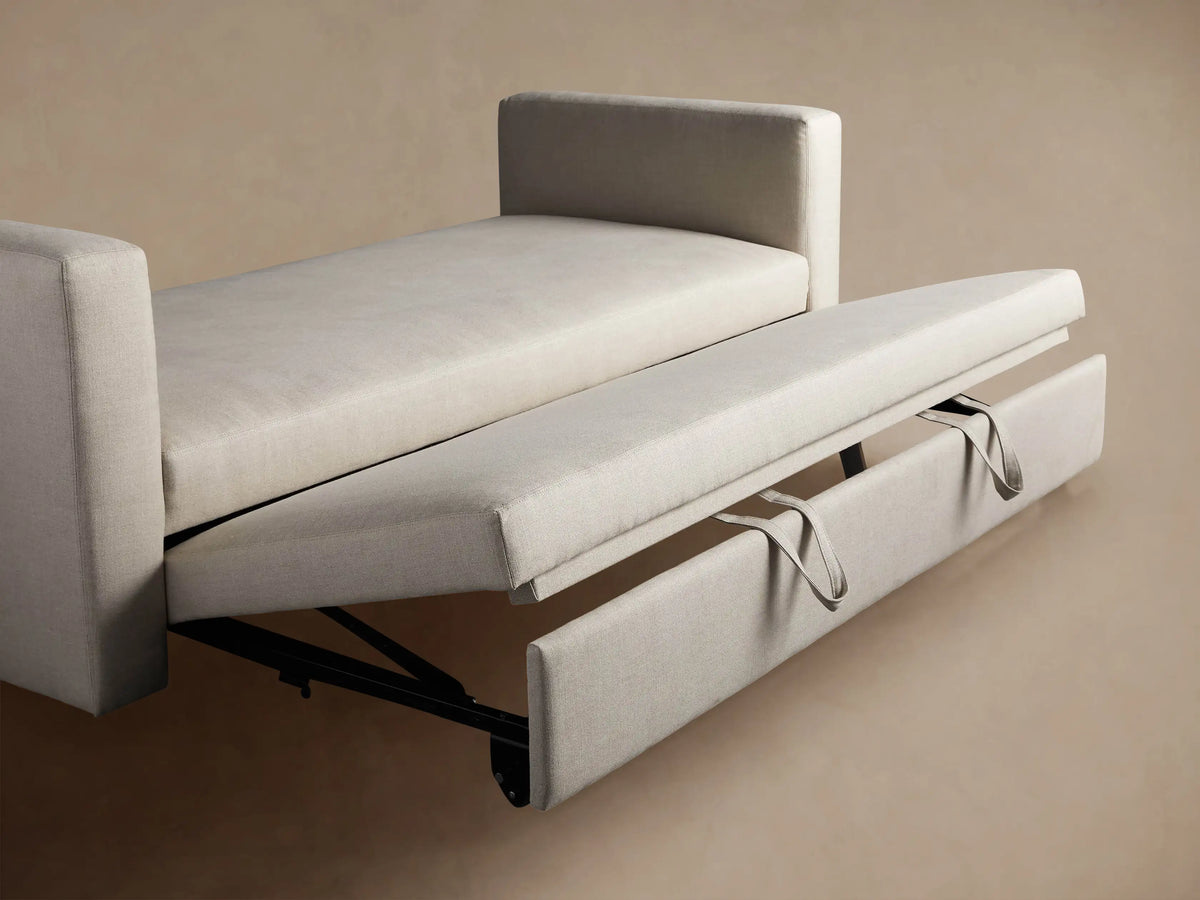 Close-up of the Remington Trundle Sleeper Daybed's armrest & seat in light greyish-beige textured fabric.
