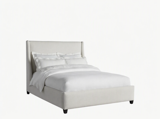 Light beige upholstered Atlyn Bed, featuring a tall, winged headboard and a low profile, dressed with white bedding.