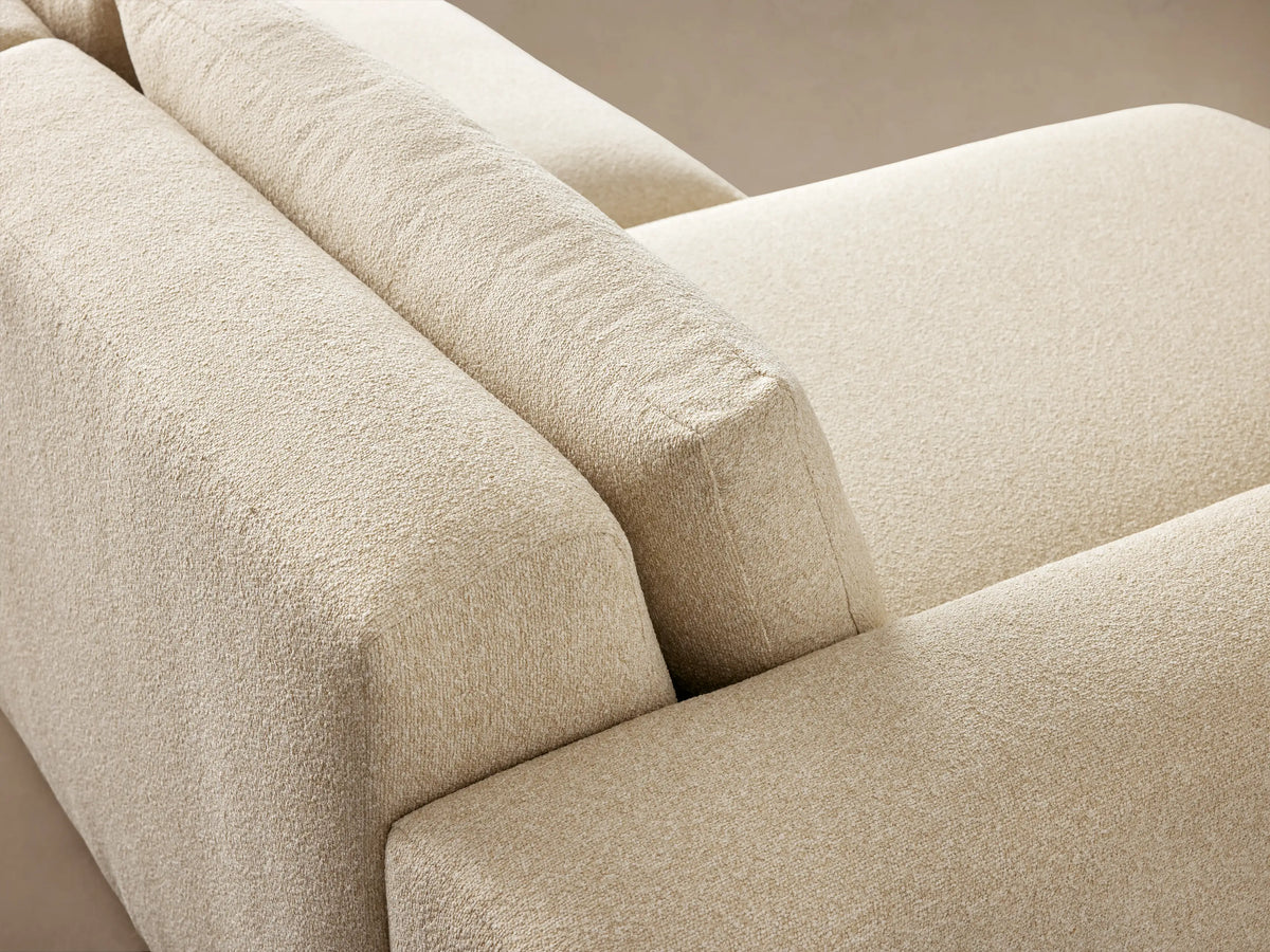 Textured light cream Keegan Three-Piece Chaise Sectional with left-facing chaise lounge, on a wooden floor.