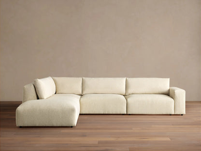 Off-white textured Keegan Tailored Four-Piece Bumper Sectional, L-shaped, with a left chaise, against a neutral wall.