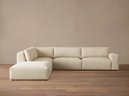 Light beige textured Keegan Tailored Five-Piece Sectional sofa with L-shape, chaise on left, on a wood floor.