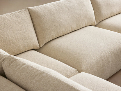 L-shaped Keegan Tailored Five-Piece Sectional in light cream textured fabric, with a chaise on wood floor.