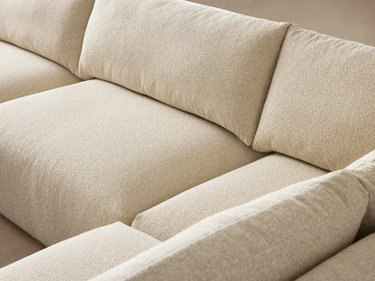 Keegan Tailored Five-Piece Sectional in L-shape, light cream textured fabric, on wood floor against a beige wall.