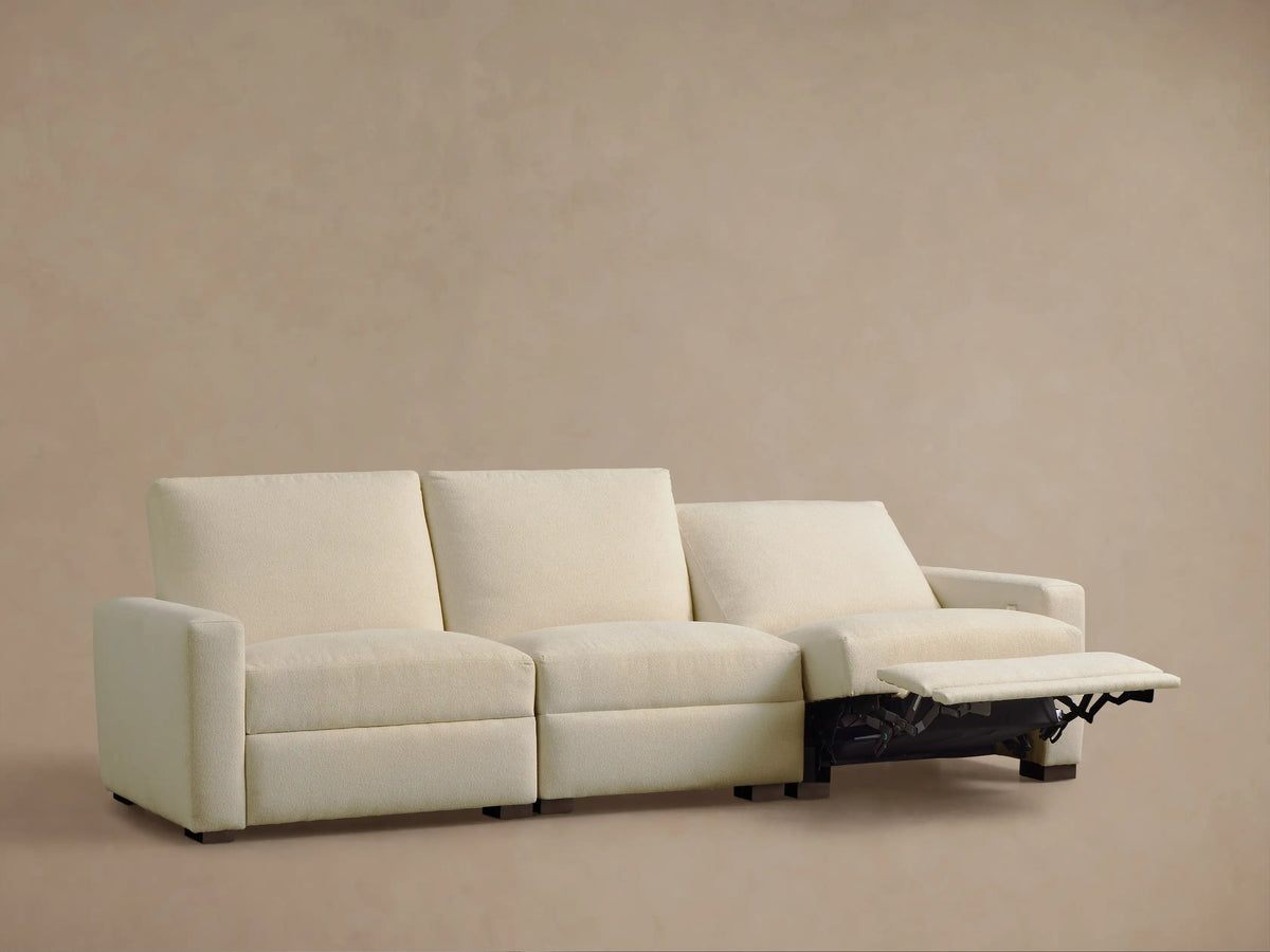 Front view of a cream textured fabric Remington Three-Piece Motion Sofa with the right recliner partially extended.