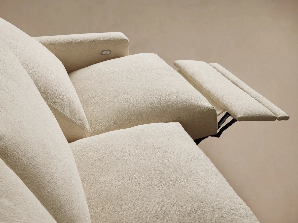 Front view of the cream Remington Three-Piece Motion Sofa, with three seats, thick cushions, and square arms.