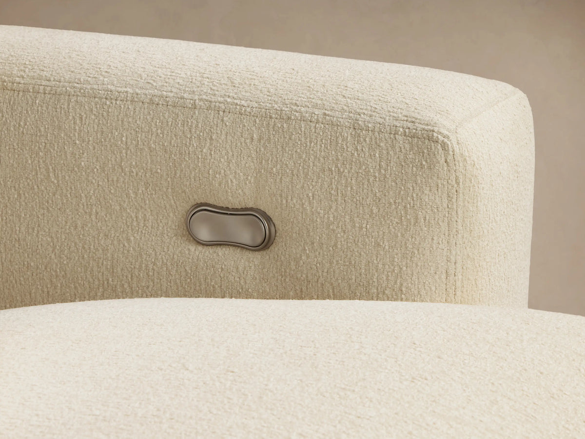 Angled close-up of cream textured Remington Three-Piece Motion Sofa with reclined footrest and control panel on arm.