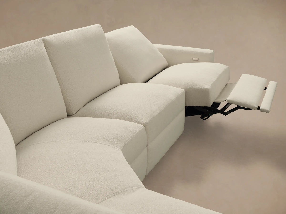 Close-up of a metallic two-button motion control on the light textured fabric side of the Remington Five-Piece Motion Corner Sectional.