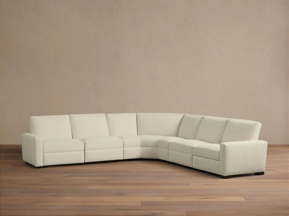 Front view of the cream Remington Five-Piece Motion Corner Sectional, with the left recliner extended.