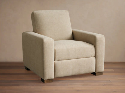 Front-quarter view of the light beige Remington Motion Recliner with square arms and dark block feet.