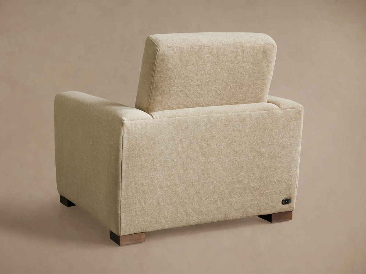 Close-up of the cream textured fabric of the Remington Motion Recliner's armrest and seat, showing a silver control panel.
