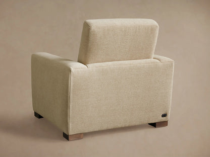 Close-up of the cream textured fabric of the Remington Motion Recliner's armrest and seat, showing a silver control panel.