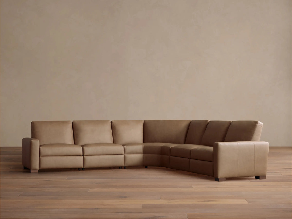 Remington Leather Five-Piece Motion Corner Sectional, L-shaped, in light brown leather on a wood floor against a light wall.
