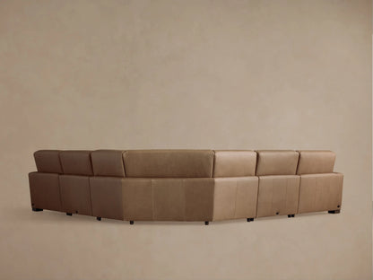 Close-up of a tan leather Remington motion corner sectional. Smooth texture, visible stitching, and an extended footrest are shown.