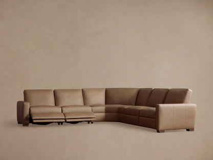 Remington Leather Five-Piece Motion Corner Sectional, back view. Light brown L-shaped sofa, segmented, against a warm neutral wall.