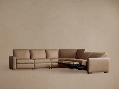 Remington Leather Five-Piece Motion Corner Sectional in tan. Left recliners extended, showing motion feature, on a neutral wall.