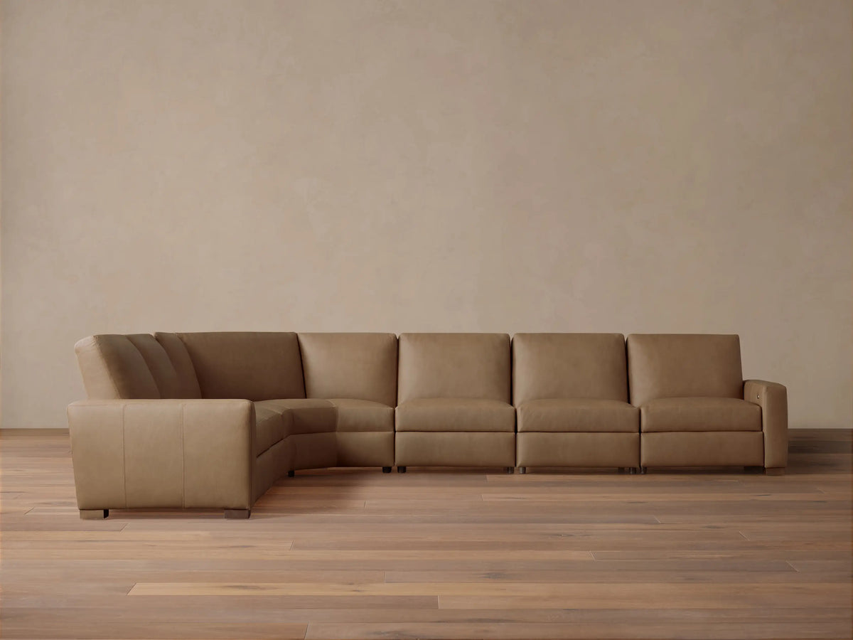 Front view of tan Remington Leather Six-Piece Motion Sectional, L-shaped, on a wood floor against a neutral wall.