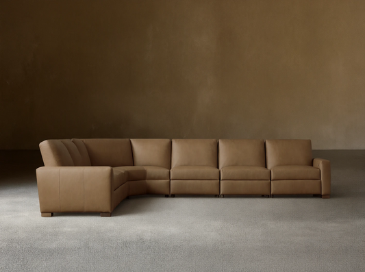 Front view of tan Remington Leather Six-Piece Motion Sectional, L-shaped, on a wood floor against a neutral wall.