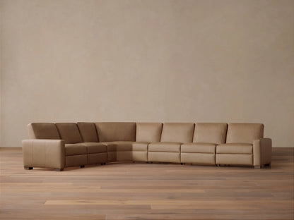 Front view of tan Remington Leather Six-Piece Motion Sectional, L-shaped, on a wood floor against a neutral wall.