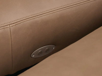 Close-up of a curved Remington Leather Six-Piece Motion Sectional in warm brown/taupe, highlighting smooth leather and detailed stitching.