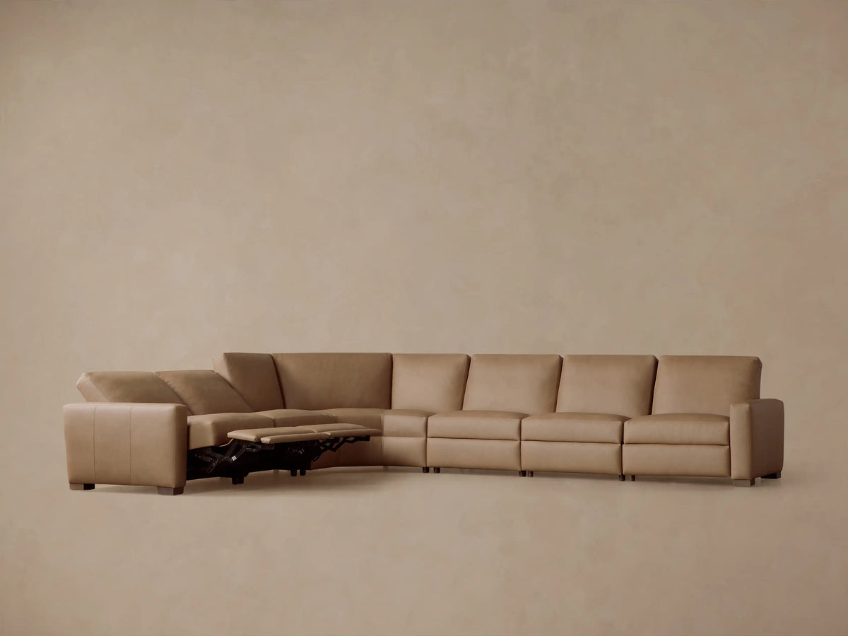 Remington six-piece L-shaped motion sectional in tan leather, with three extended recliners, on a neutral background.