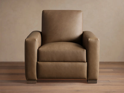 Light brown leather Remington Motion Recliner, a modern armchair with wide arms, seen from the front on wood floor.