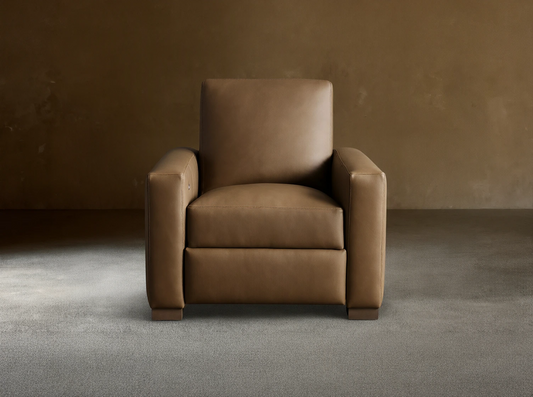 Light brown leather Remington Motion Recliner, a modern armchair with wide arms, seen from the front on wood floor.