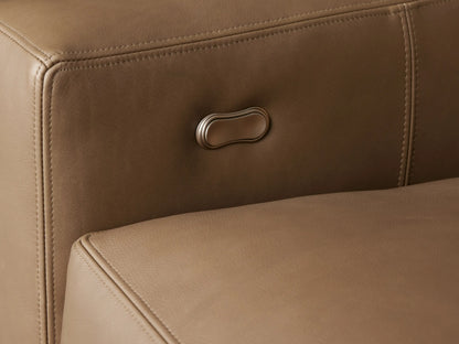 Remington Leather Motion Recliner in tan leather, angled view, showing block arms and plush seat on a wood floor.