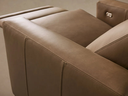 Close-up of Remington Leather Motion Recliner in tan leather, showing detailed stitching and a metallic power recline button.